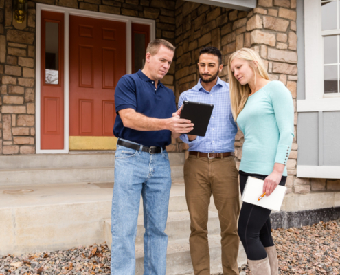 An inspector reviewing a report with a couple